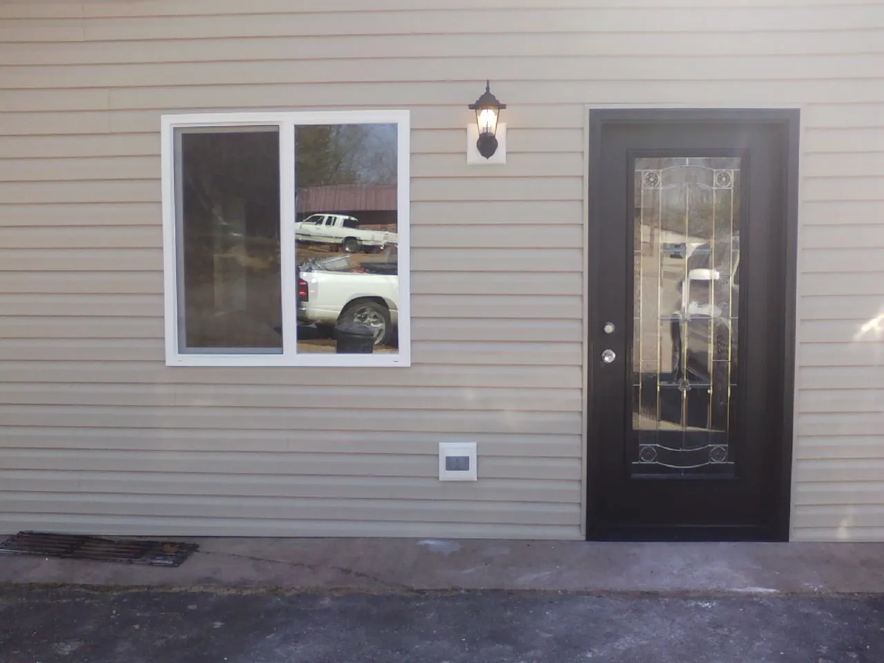 New siding, window and entry door on the side of an addition in Cat Spring